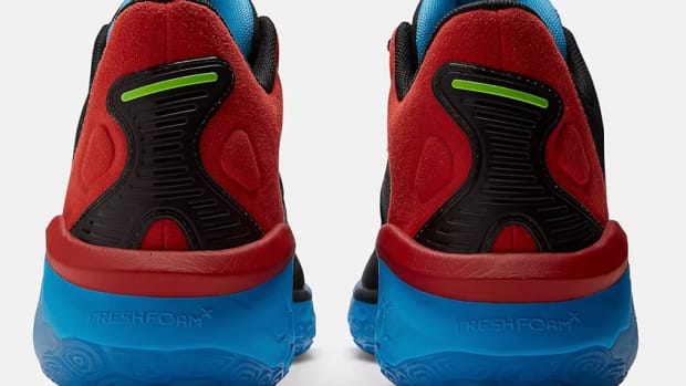 Rear view of red and blue New Balance shoes.